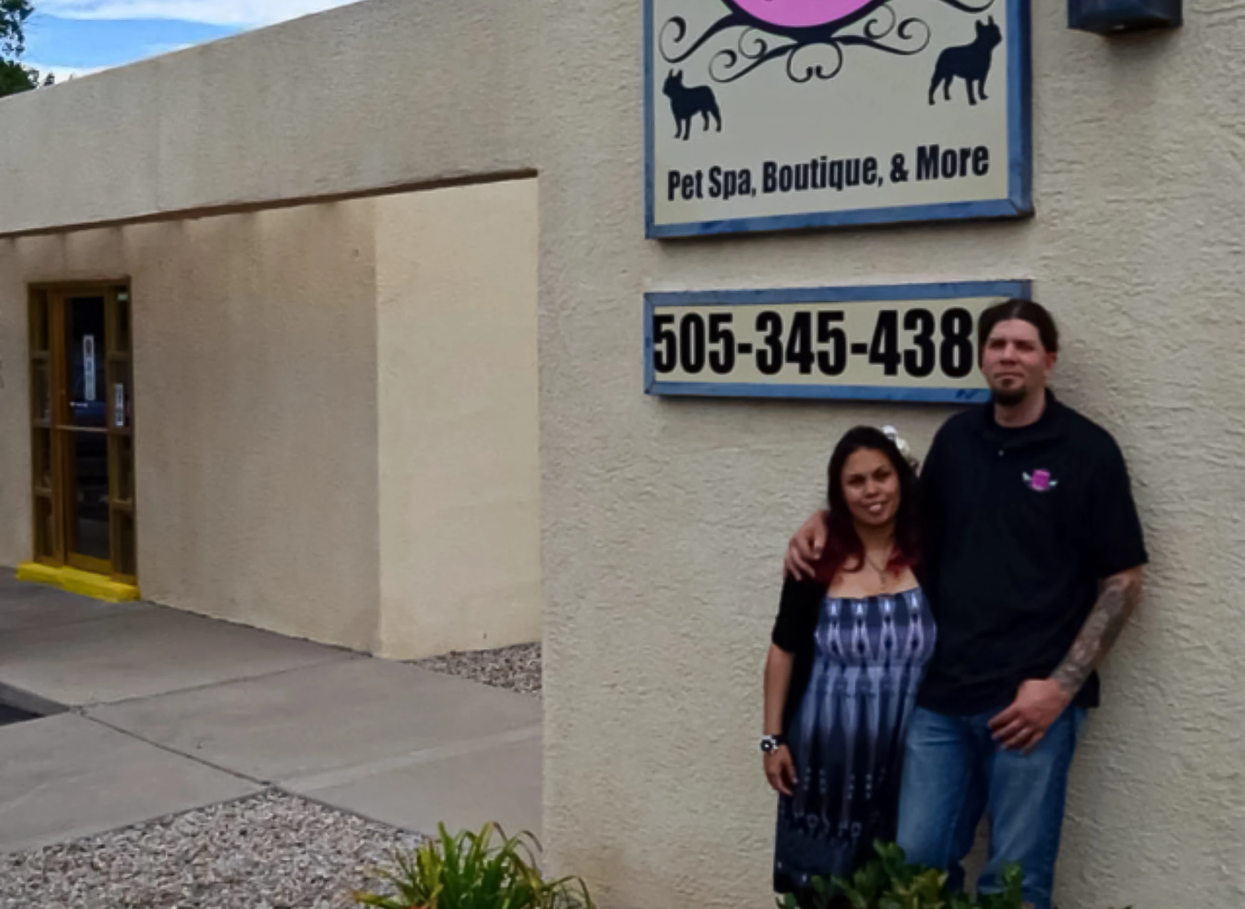 Woman and man standing in front of their shop